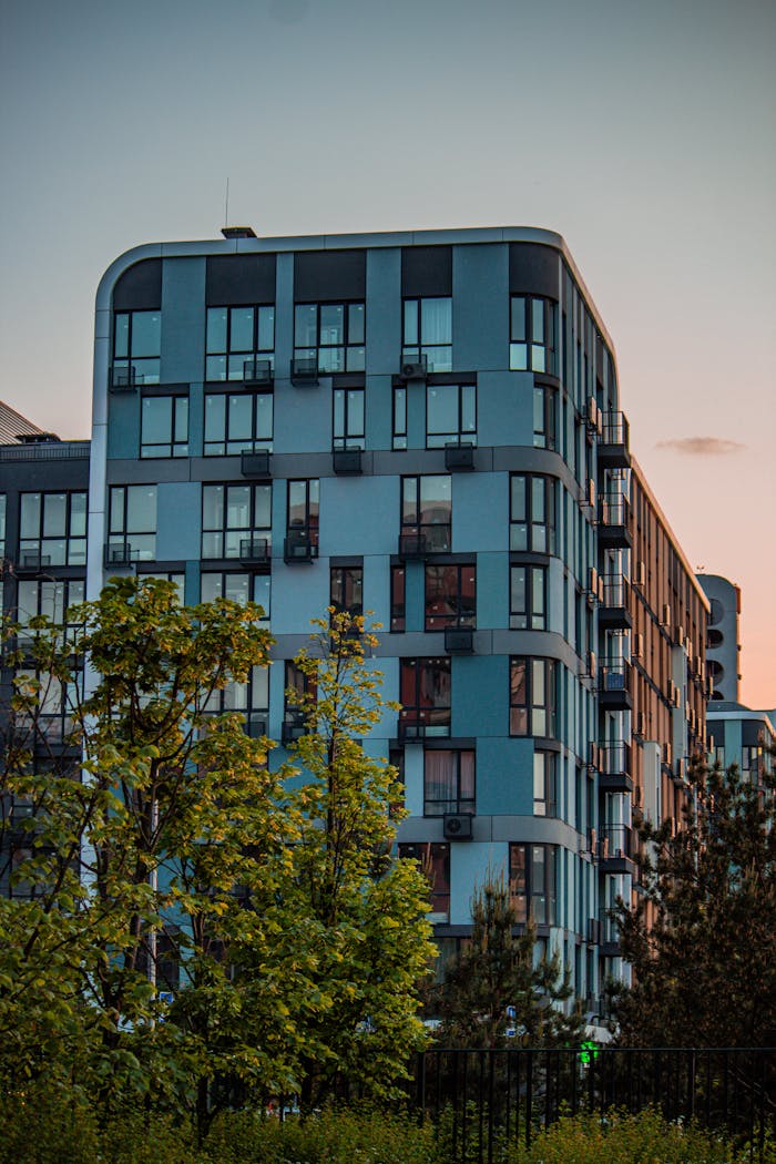 about-us-01 Contemporary apartment building in Kyiv during sunset, featuring modern architecture.