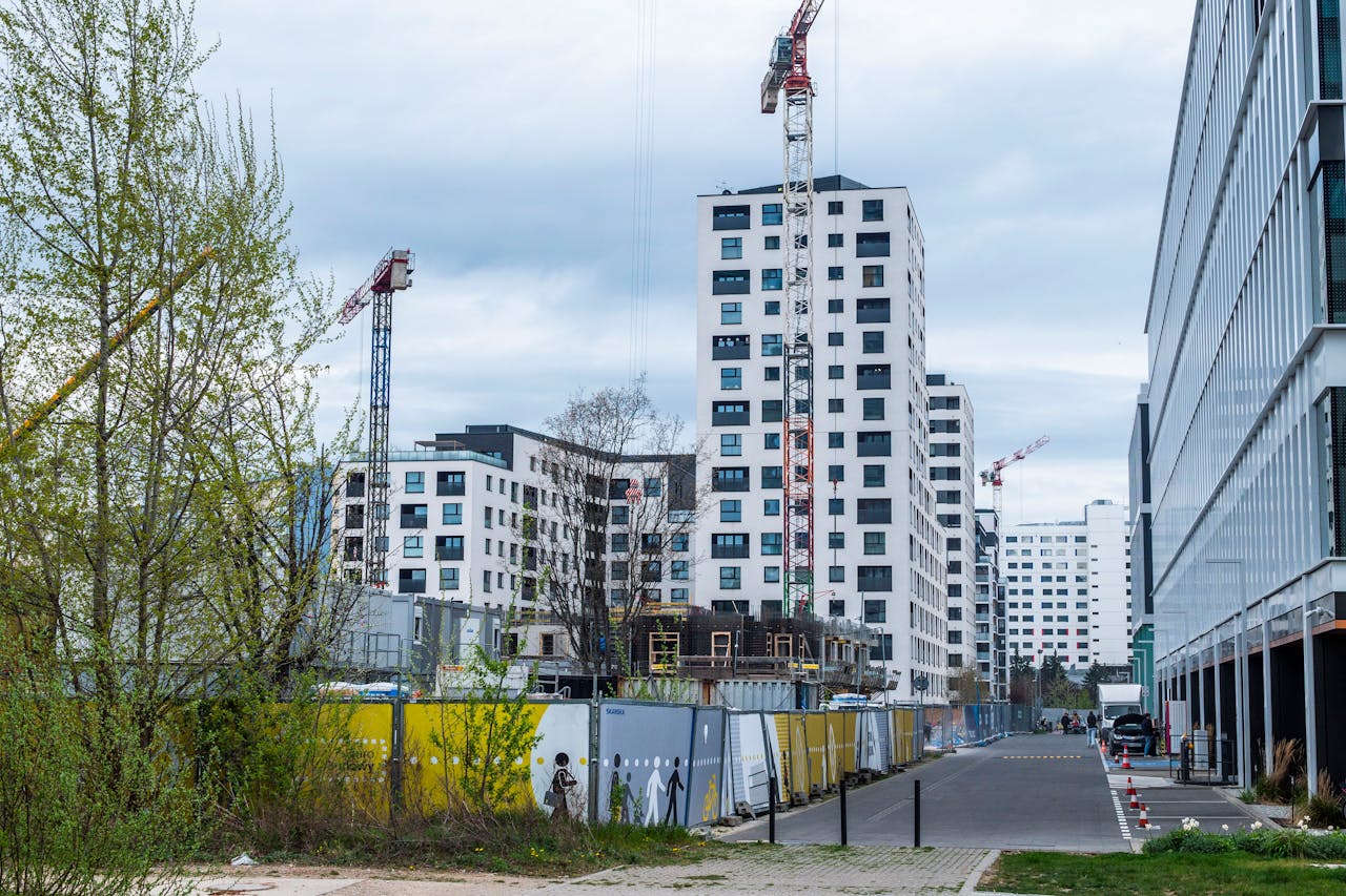 High-rise buildings and cranes in an urban construction site. Modern architecture.