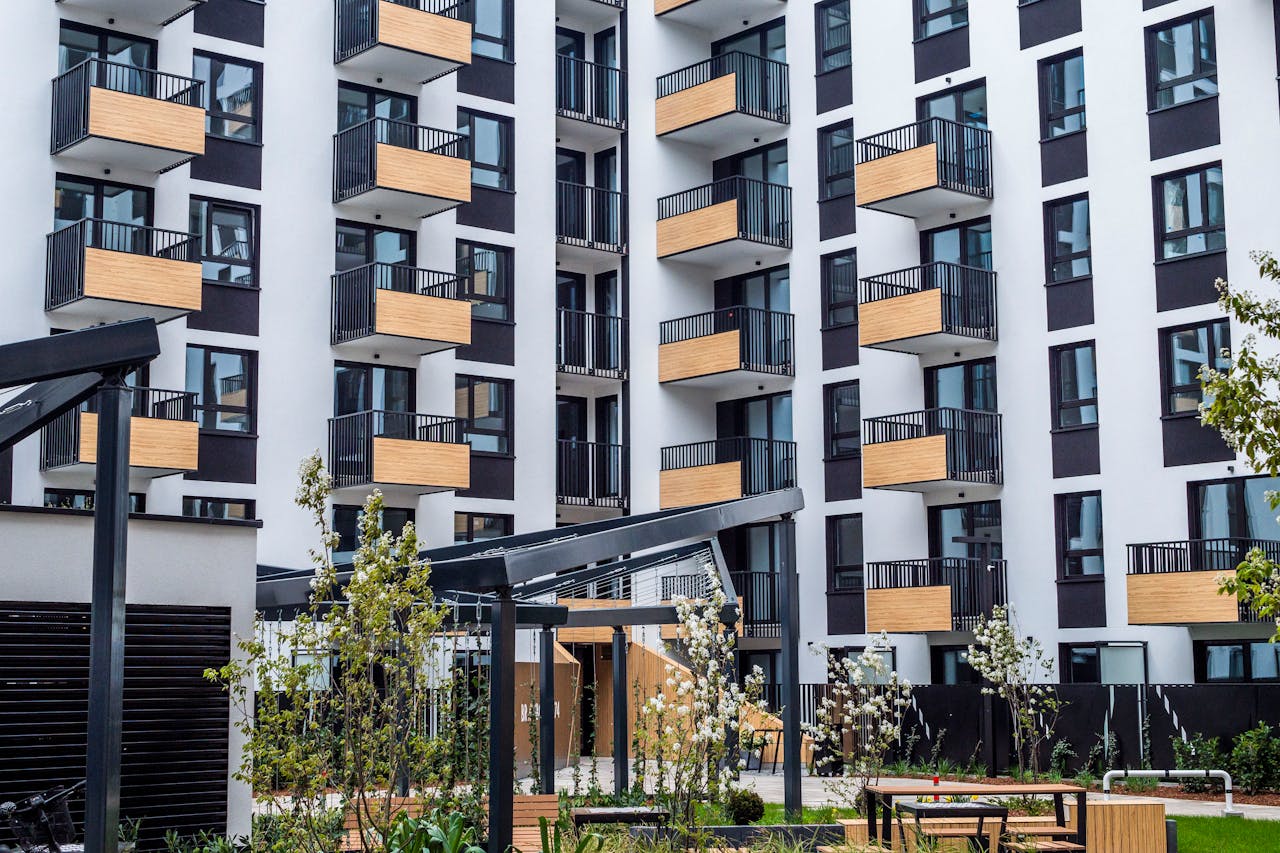 gallery-02 Contemporary apartment building with balconies and garden in spring.